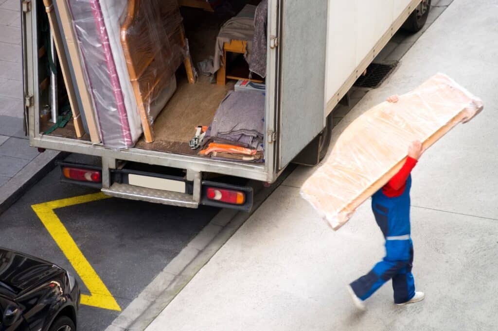 A traditional removals truck with disassembled furniture on a moving day