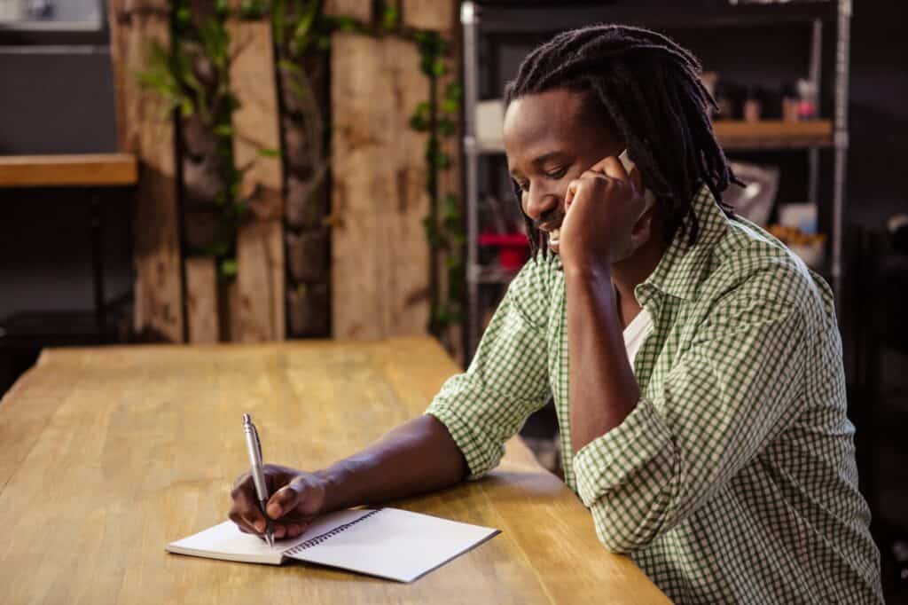A man speaking with a Man and Van on the phone to get quotes