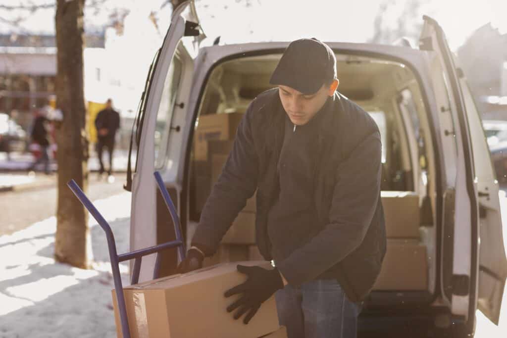 A Man with a Van unloading boxes on a winter day