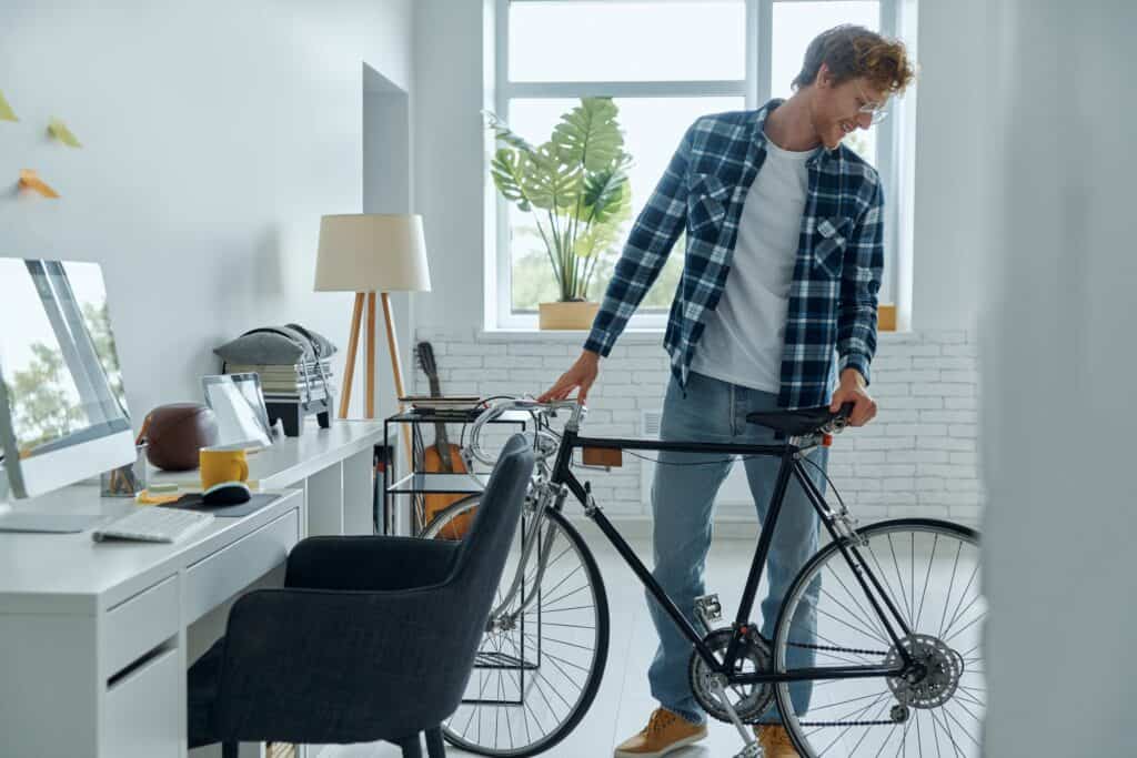 A man at his home office checking his bike before the move