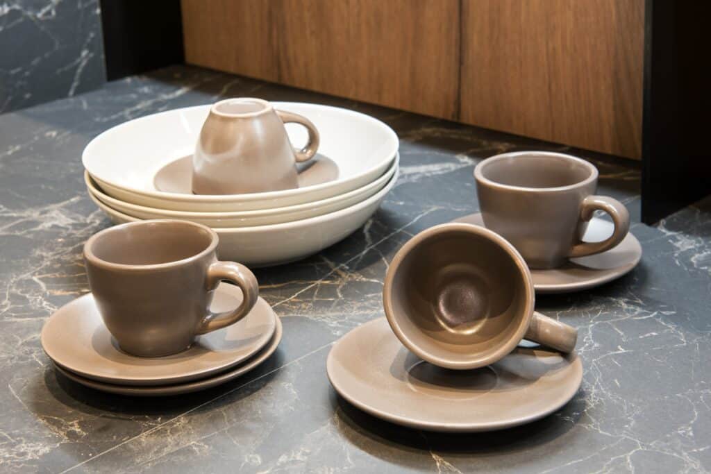 Coffee cups and saucers outside the cabinet for packing